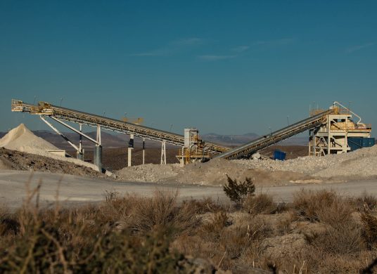 Conveyors depositing material at a calcium mine in the desert.